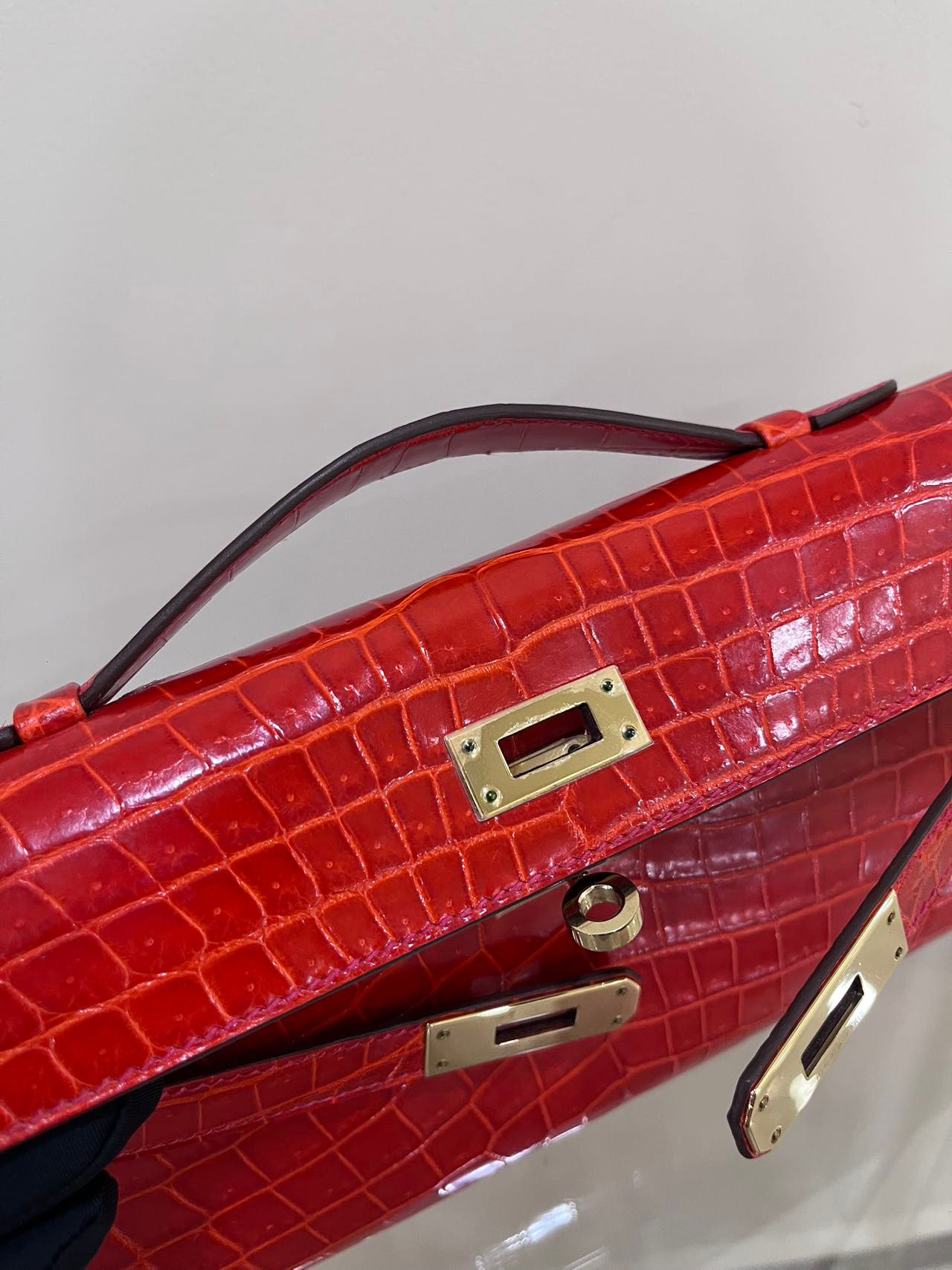 Hermes Kelly cut red shiny crocodile leather gold hardware