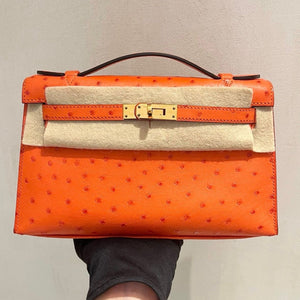 Hermes Kelly Pochette tangerine ostrich gold hardware