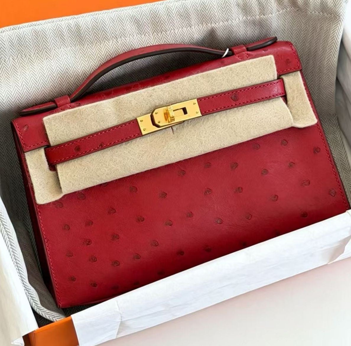 Hermès Kelly pochette rouge vif ostrich gold hardware