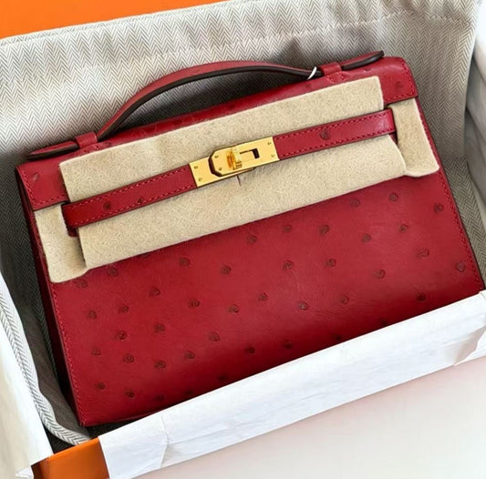 Hermès Kelly pochette rouge vif ostrich gold hardware