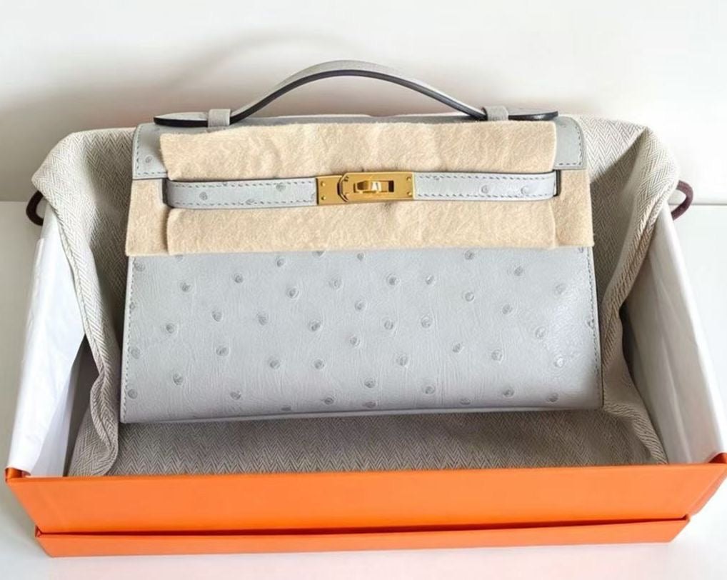 Hermès Kelly pochette blue glacier ostrich gold hardware