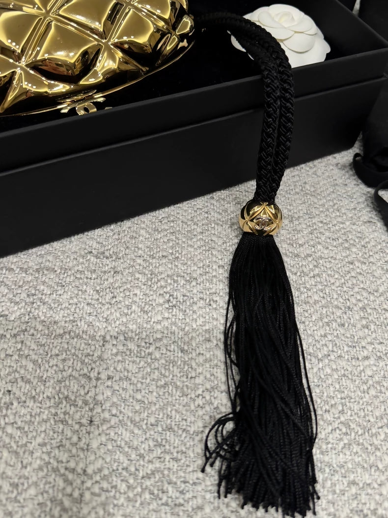 Chanel 26P gold oval evening clutch featuring the signature diamond quilting and a tassel adornment