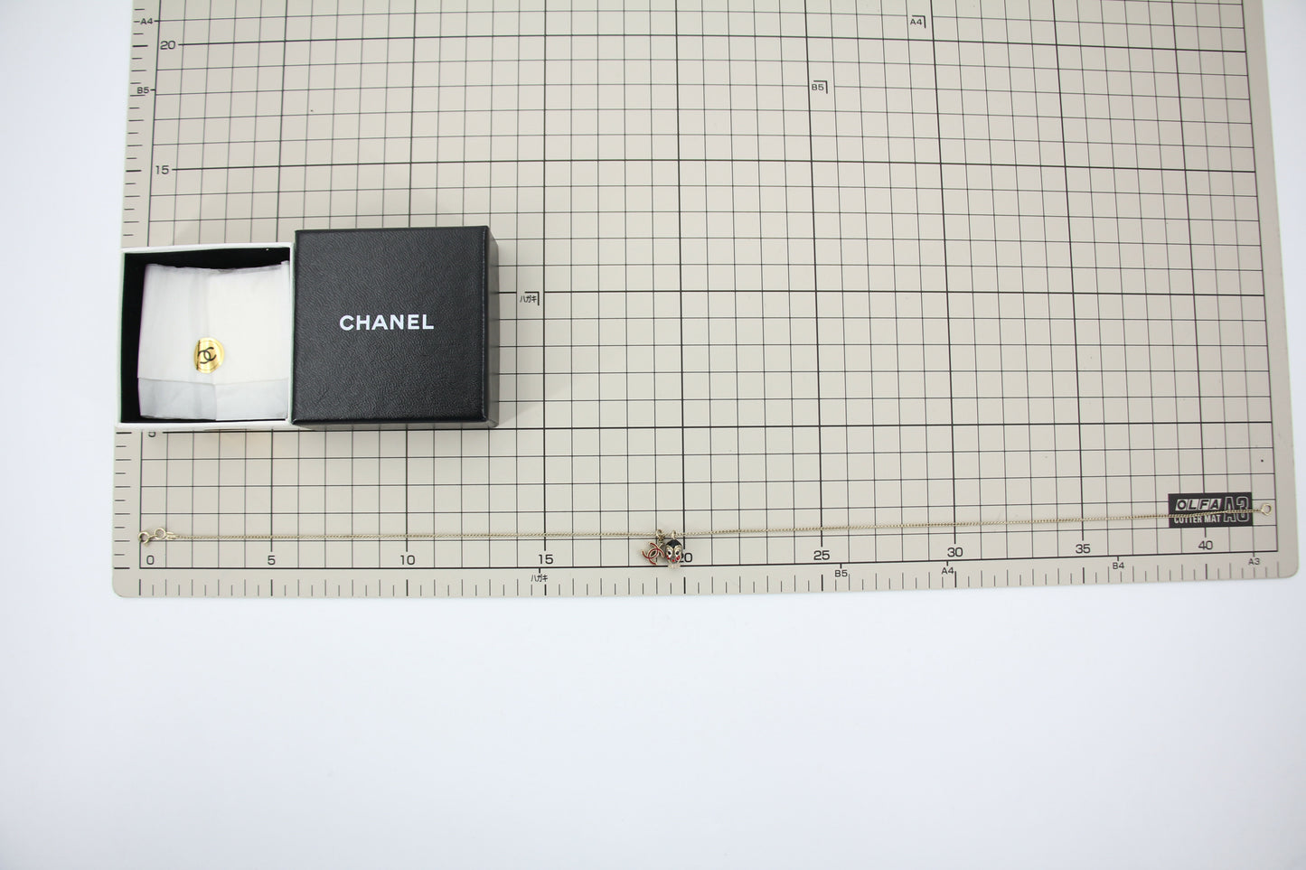 Chanel Vintage 05P Metal Doll Head Red CC Necklace