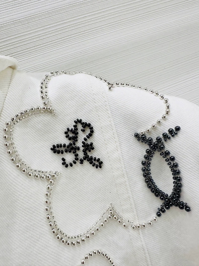 Chanel Métiers dArt white denim jacket with beaded camellia