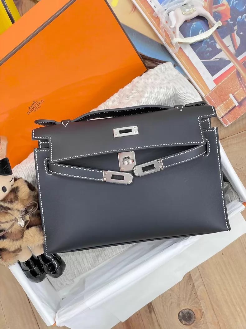 Hermès Kelly Pochette Black Swift leather with white stitching palladium hardware