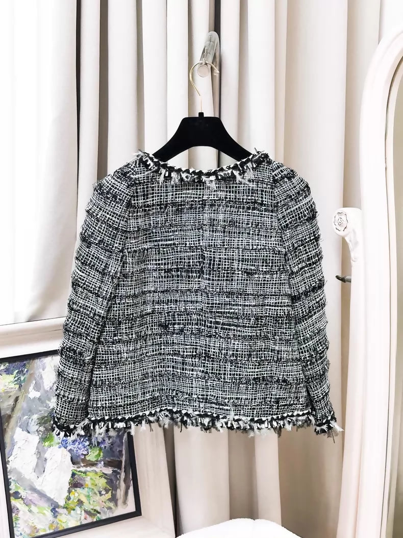 Chanel Spring/Summer 2011 black and white tweed jacket.