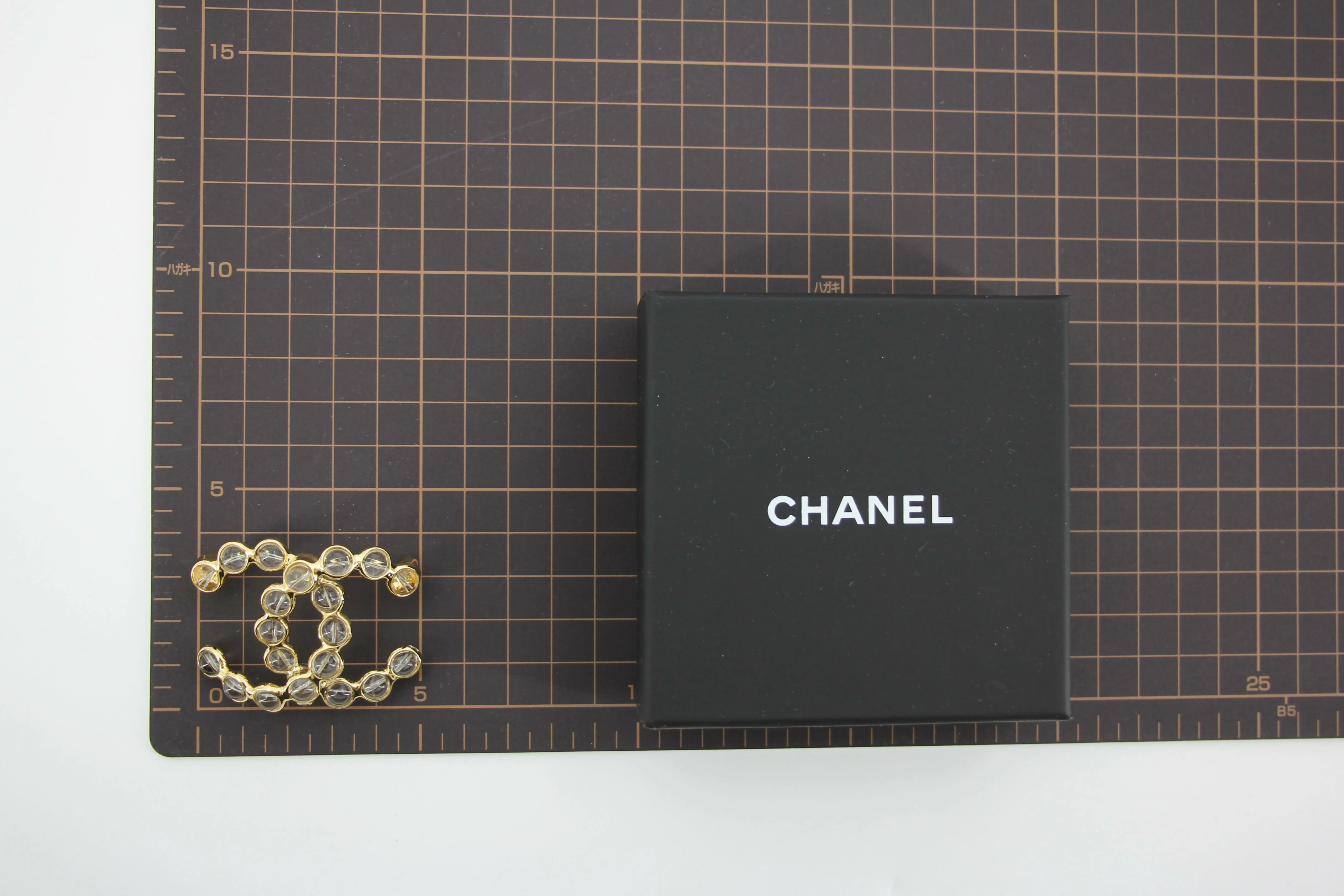 Chanel A24S Acrylic CC Champagne Gold Transparent Brooch