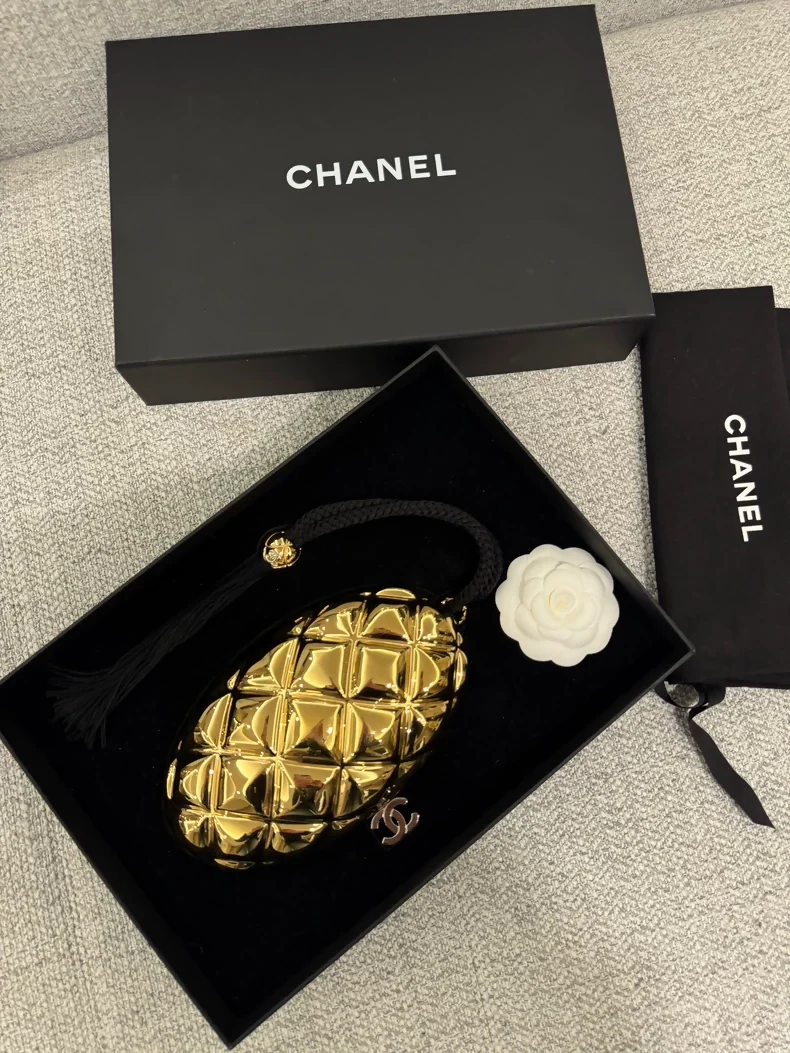 Chanel 26P gold oval evening clutch featuring the signature diamond quilting and a tassel adornment